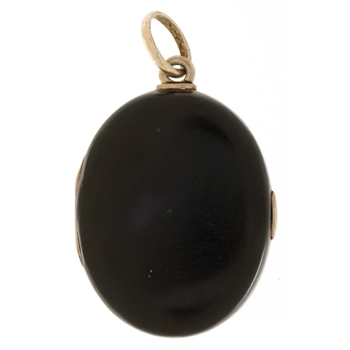 3491 - A Victorian black enamel and seed pearl mourning locket, 5.5cm high, 33.0g.