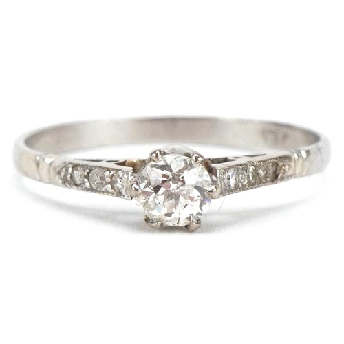 3063 - A platinum diamond solitaire ring with diamond set shoulders, the central diamond approximately 0.25... 