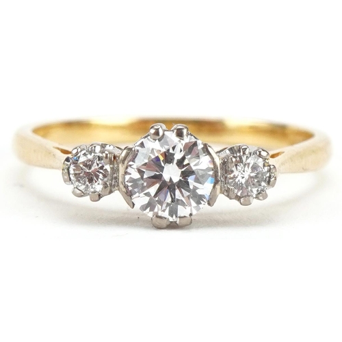 3034 - An 18ct gold diamond trilogy ring, the central diamond approximately 0.60 carat, size Q/R, 3.0g.