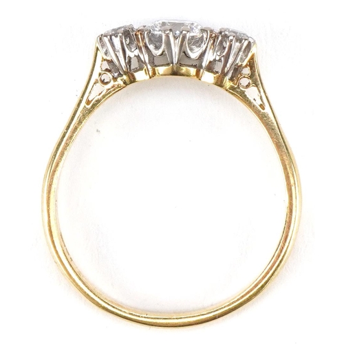 3034 - An 18ct gold diamond trilogy ring, the central diamond approximately 0.60 carat, size Q/R, 3.0g.