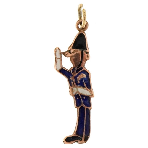 3664 - A 9ct gold and enamel charm in the form of a Police officer, 2.4cm high, 1.2g.