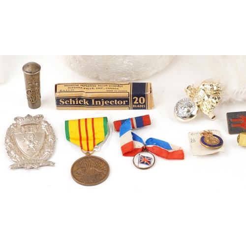 2426 - Militaria including a flat cap with Royal Marines badge, Royal Welsh beret, enamelled badges, HMS Ir... 