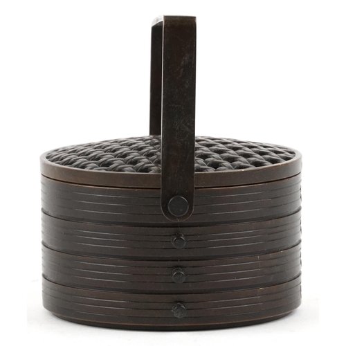 375 - A Japanese patinated bronze cricket cage in the form of a food carrier with swing handle, 8cm in dia... 