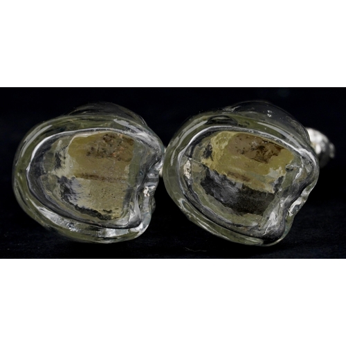 1087 - A pair of novelty glass salt and pepper casters with silver plated heads in the form of dogs, each 8... 