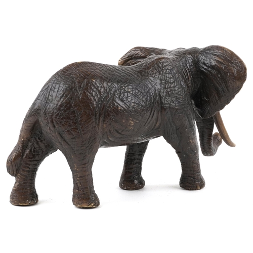 1065 - A Japanese patinated bronze okimono of an elephant, 20th century, 30cm in length.