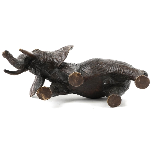 1065 - A Japanese patinated bronze okimono of an elephant, 20th century, 30cm in length.