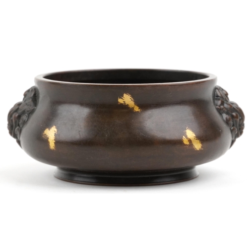 106 - A Chinese gold splashed patinated bronze censer with dragon head handles, character marks to the bas... 