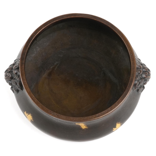 106 - A Chinese gold splashed patinated bronze censer with dragon head handles, character marks to the bas... 