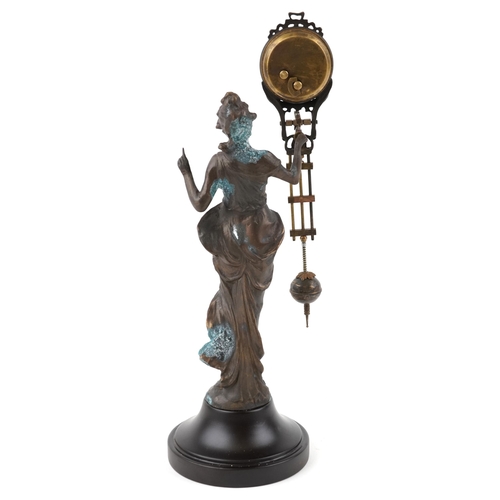 1084 - A patinated spelter mystery clock in the form of an Art Nouveau maiden, 33.5cm high.