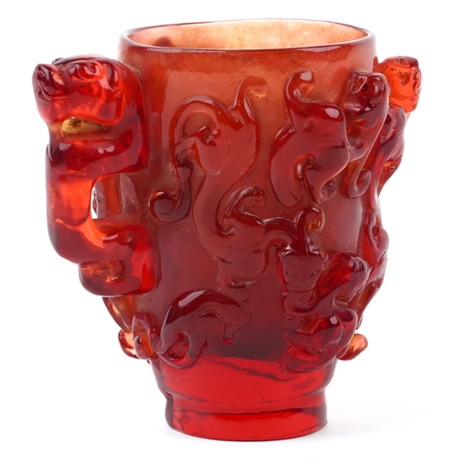 402 - A Chinese carved cherry amber libation cup, 20th century, relief decorated with dragons, H-13cm, 558... 