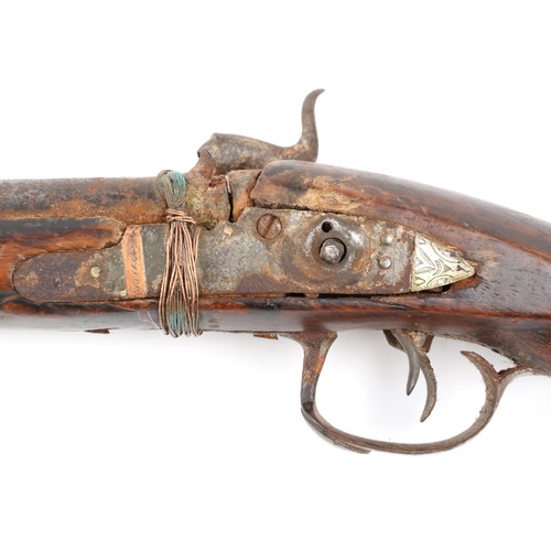 2554 - An antique Middle Eastern double barrel flintlock rifle, the wooden stock carved with a serpent head... 