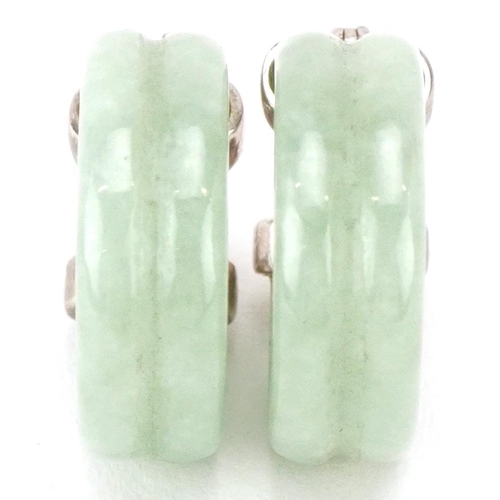 3476 - A pair of silver mounted Chinese green jade hoop earrings, 2.3cm high, total 8.6g.