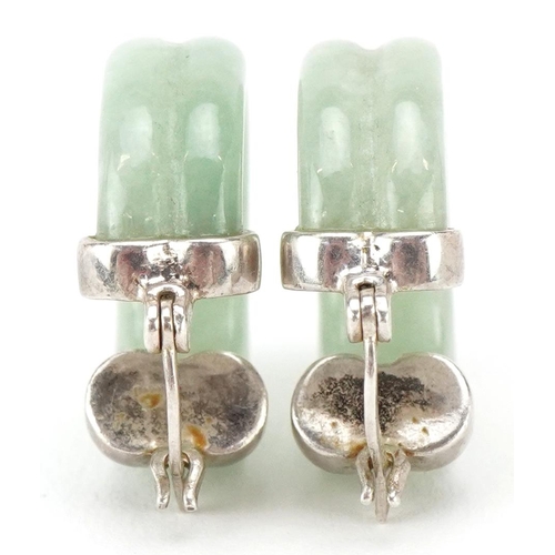 3476 - A pair of silver mounted Chinese green jade hoop earrings, 2.3cm high, total 8.6g.