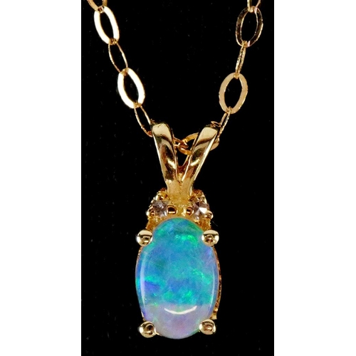 3064 - A 10ct gold cabochon opal and diamond pendant on a 9ct gold necklace, 11mm high and 44cm in length, ... 