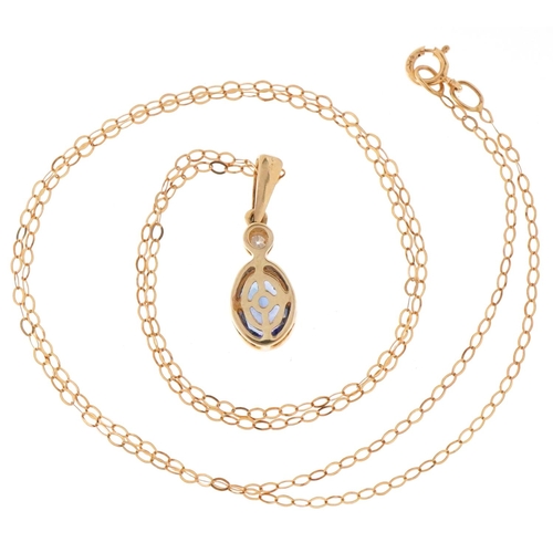 3083 - An unmarked gold tanzanite and diamond pendant on a 9ct gold necklace, 2cm high and 44cm in length, ... 