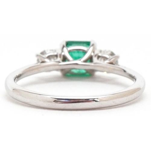 3408 - An 18ct white gold emerald and diamond trilogy ring, the emerald weight approximately 0.66 carat, to... 