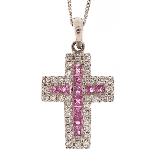 3173 - An 18ct white gold and sapphire cross pendant on an 18ct white gold chain, total sapphire weight app... 