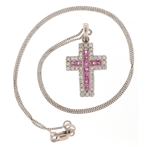 3173 - An 18ct white gold and sapphire cross pendant on an 18ct white gold chain, total sapphire weight app... 