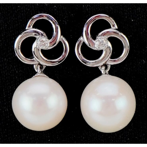 3109 - A pair of 9ct white gold freshwater pearl and diamond drop earrings, total diamond weight approximat... 