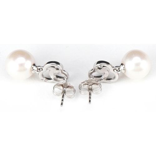 3109 - A pair of 9ct white gold freshwater pearl and diamond drop earrings, total diamond weight approximat... 