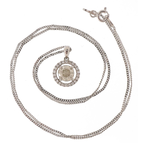 3348 - A platinum and diamond halo pendant on a silver fine link necklace, the central diamond approximatel... 