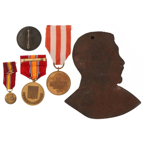 2422 - Four German military interest medals and a cast iron plaque of Adolf Hitler.