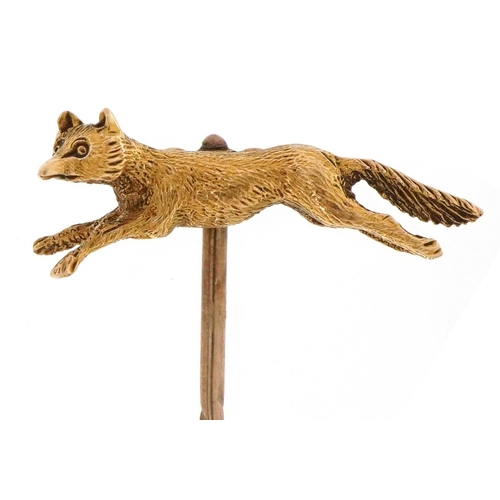 3031 - An antique unmarked 15ct gold and yellow metal stickpin in the form of a fox, 6cm in length, 3.1g.