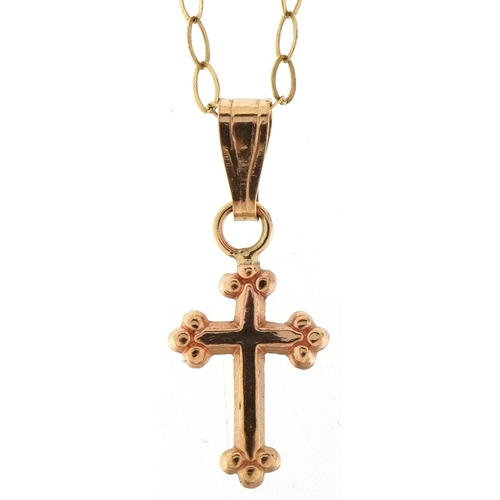 3170 - A 9ct gold cross pendant on a fine 9ct gold necklace, 1.7cm high and 40cm in length, total 0.5g.