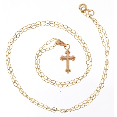 3170 - A 9ct gold cross pendant on a fine 9ct gold necklace, 1.7cm high and 40cm in length, total 0.5g.