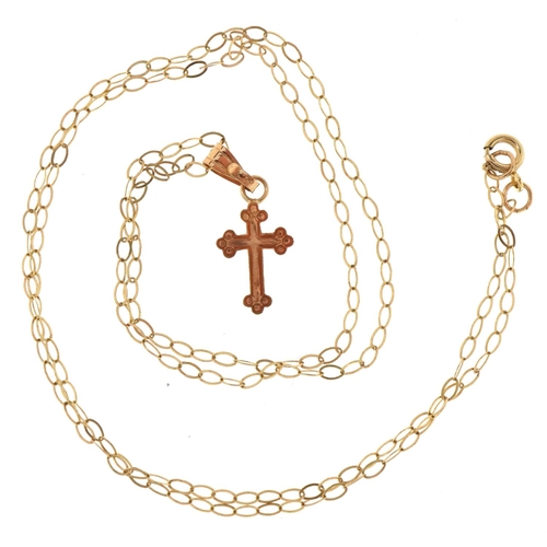 3170 - A 9ct gold cross pendant on a fine 9ct gold necklace, 1.7cm high and 40cm in length, total 0.5g.