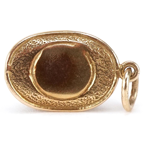 3068 - A 9ct gold charm in the form of a magician's hat opening to reveal an enamelled bunny, 20mm in lengt... 