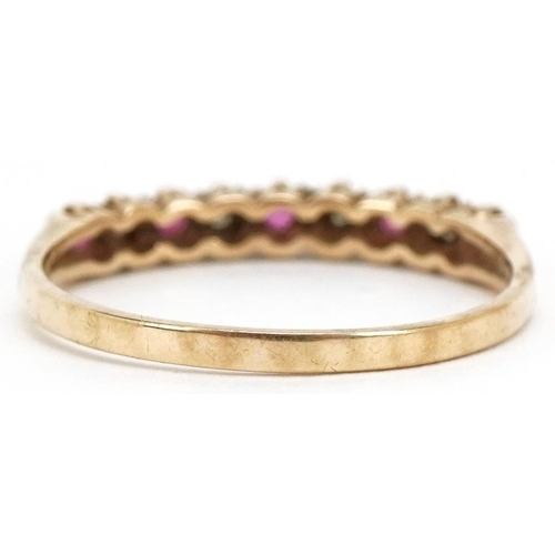 3504 - A 9ct gold diamond and ruby half eternity ring, size O, 1.3g.