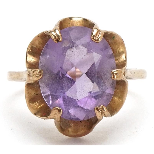 3230 - A 9ct gold amethyst solitaire ring with ornate setting, size M, 3.1g.