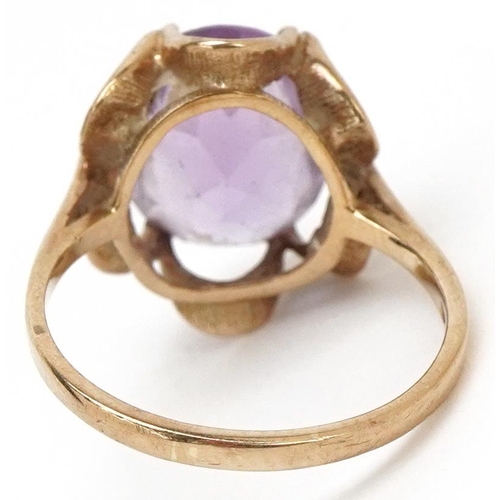 3230 - A 9ct gold amethyst solitaire ring with ornate setting, size M, 3.1g.