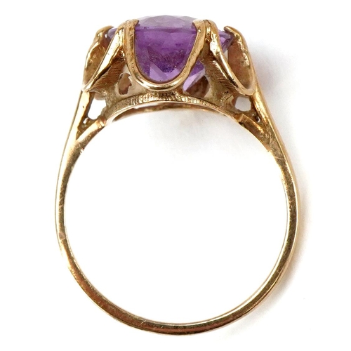 3230 - A 9ct gold amethyst solitaire ring with ornate setting, size M, 3.1g.