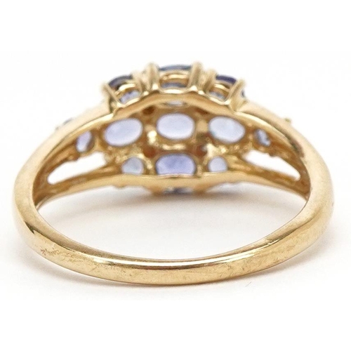 3205 - A 9ct gold iolite and diamond cluster ring, size M, 2.4g.