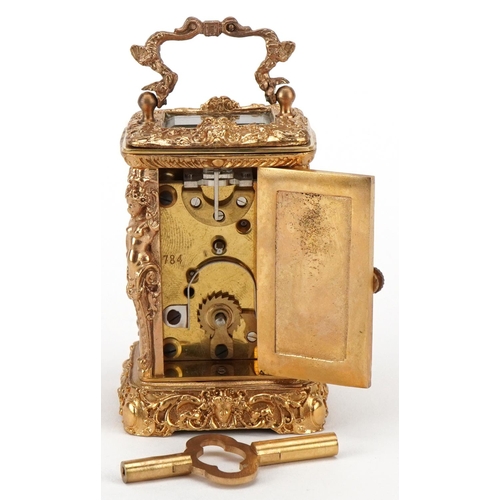 234 - A miniature gilt brass Rococo style carriage clock, the enamelled dial with Roman numerals and swing... 