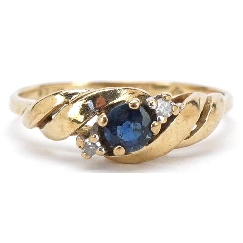 3216 - A 9ct gold sapphire and diamond three stone crossover ring, size K/L, 1.7g.