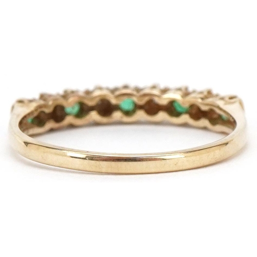 3503 - A 9ct gold emerald and diamond half eternity ring, size N/O, 1.6g.