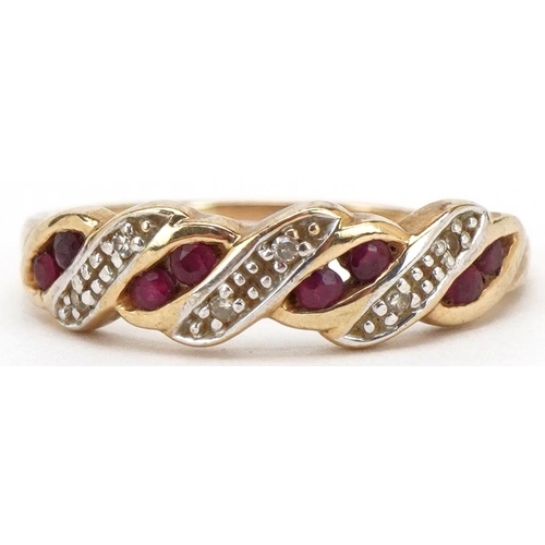 3190 - A 9ct gold diamond and ruby crossover half eternity ring, size O, 2.0g.