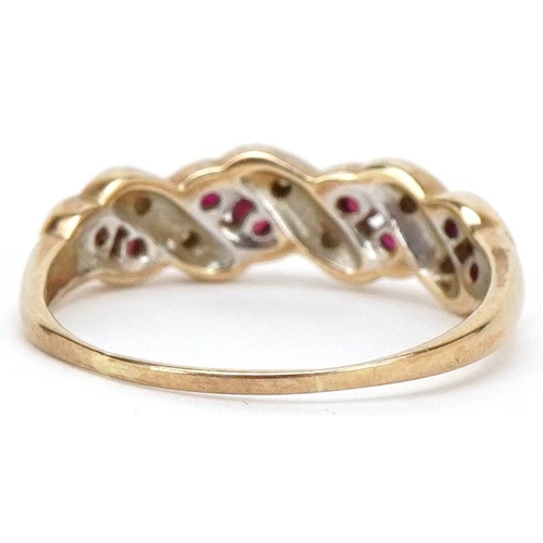 3190 - A 9ct gold diamond and ruby crossover half eternity ring, size O, 2.0g.