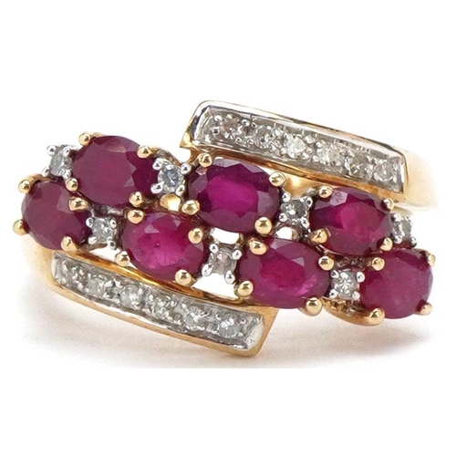 3144 - A 9ct gold ruby and diamond crossover dress ring, size M, 2.7g.