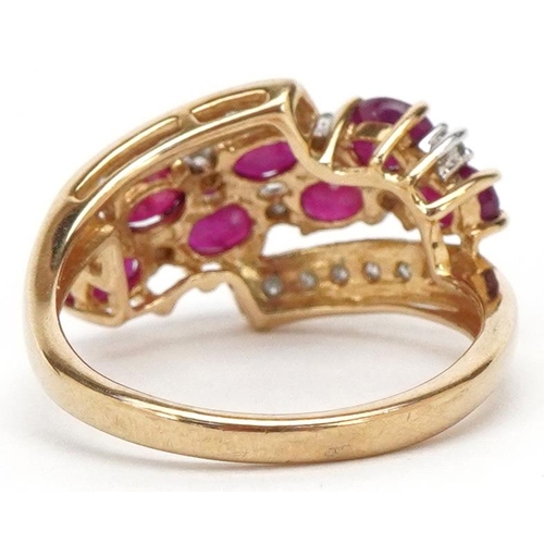 3144 - A 9ct gold ruby and diamond crossover dress ring, size M, 2.7g.