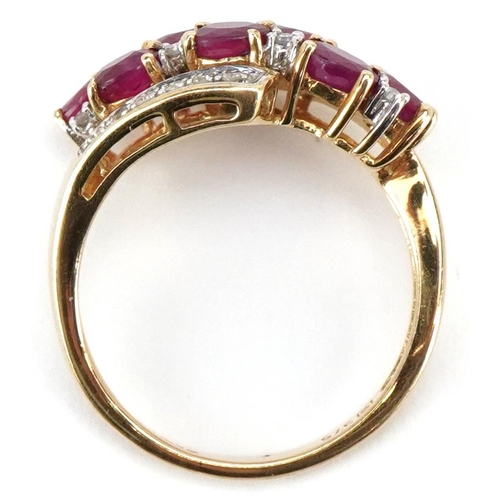 3144 - A 9ct gold ruby and diamond crossover dress ring, size M, 2.7g.