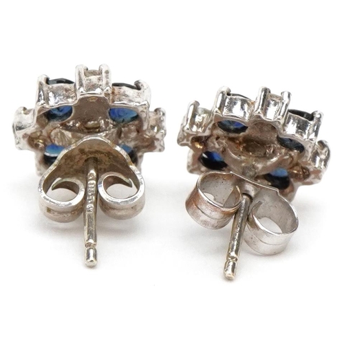 3209 - A pair of 9ct white gold diamond and sapphire cluster stud earrings, overall 10mm in diameter, total... 