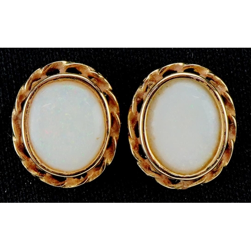 3499 - A pair of 9ct gold cabochon opal stud earrings, 12.5mm high, total 2.1g.