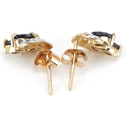 3233 - A pair of unmarked gold sapphire and diamond floral stud earrings, 9.5mm high, total 1.1g.