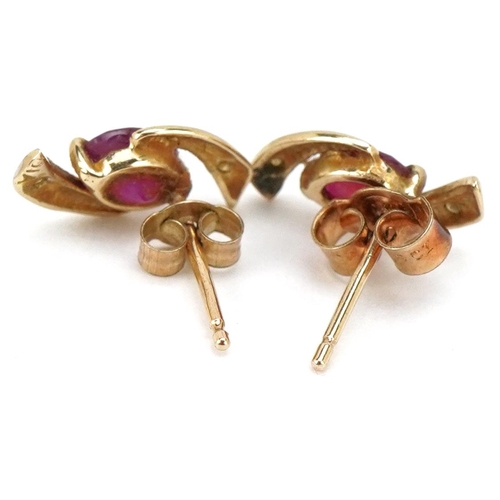 3464 - A pair of 9ct gold ruby and diamond stud earrings, 12.0mm high, total 1.0g.