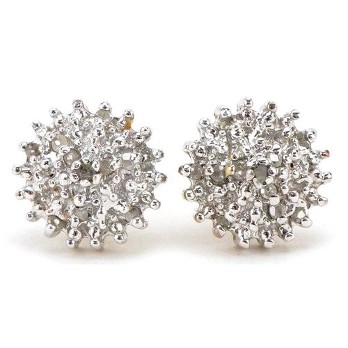 3059 - A pair of unmarked gold diamond four tier cluster stud earrings, 9.0mm in diameter, total 1.7g.