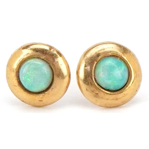 3409 - A pair of unmarked gold cabochon opal stud earrings, 6.2mm in diameter, total 1.3g.